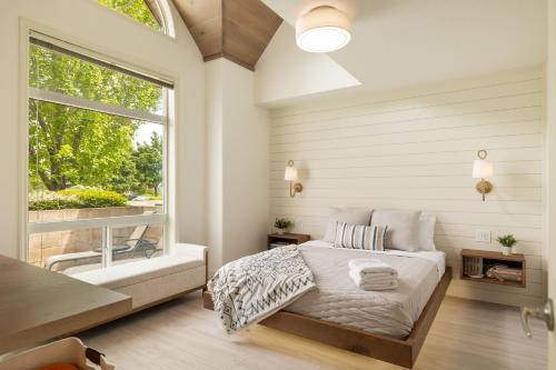 a bedroom with a bed and a large window at sunset 101 in Kelowna