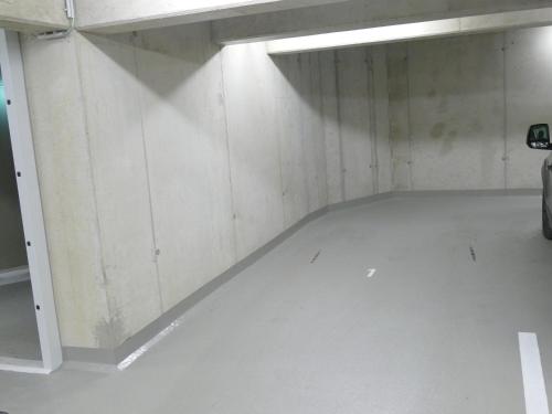 an empty garage with a car parked in it at Chads City Apartment mit Tiefgarage free parking in Graz