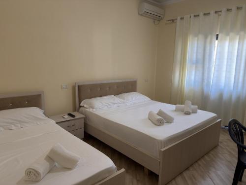 two beds in a bedroom with towels on them at Blue Shore in Golem
