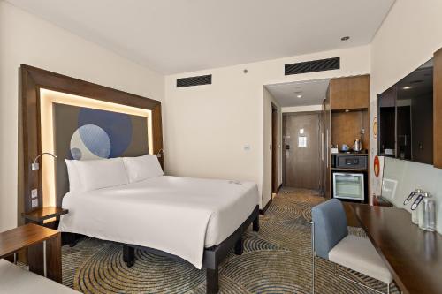 a hotel room with a bed and a kitchen at Novotel Abu Dhabi Gate in Abu Dhabi