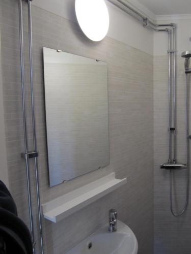 a bathroom with a sink and a mirror at Klarälvens Camping in Stöllet