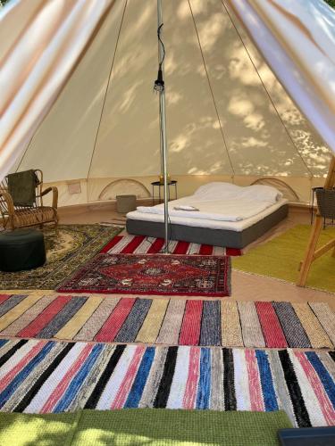 a room with a bed in a tent at Glamping by the sea in Äggrund