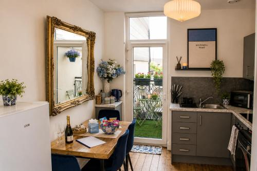 a kitchen with a table and a mirror at Lavina by the sea in Bangor