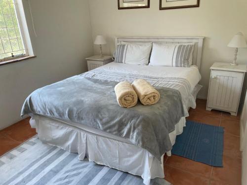 a bedroom with a bed with two towels on it at lagoon value ! in Langebaan