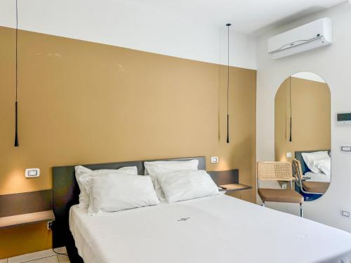 a bedroom with a large bed with white pillows at Miramare Suites in Vasto