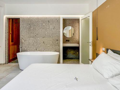 a bedroom with a bath tub and a bed at Miramare Suites in Vasto