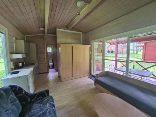 a living room with a couch and a kitchen at Giruliu kopa in Melnragė