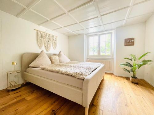 a bedroom with a bed and a large window at Appartement "Suite Seeliebe" in Tägerwilen