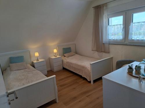 a bedroom with two beds and a desk with two lamps at Ferienhaus Zerbst in Zerbst