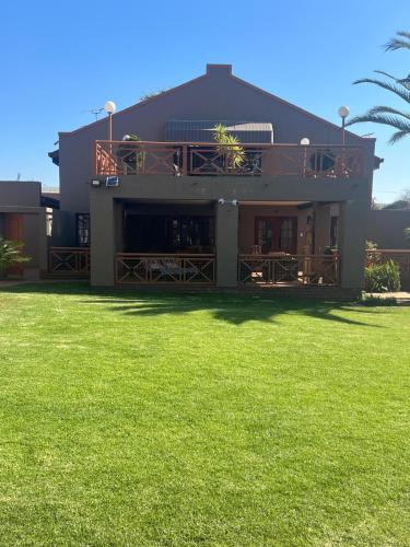 a building with a green lawn in front of it at Executive Serviced Home in Johannesburg