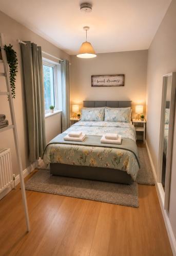 a bedroom with a bed with two towels on it at Judys View in Cashel