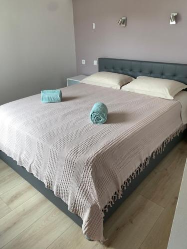 a bed with a blue hat on top of it at Escapade Vallée du Doux in Tournon-sur-Rhône