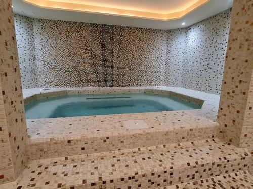 a large bath tub in a room with tiles at RELAX-zepter in Vrnjačka Banja
