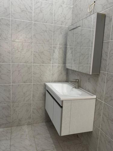 a bathroom with a white sink and a mirror at Mitty Residence in Conakry