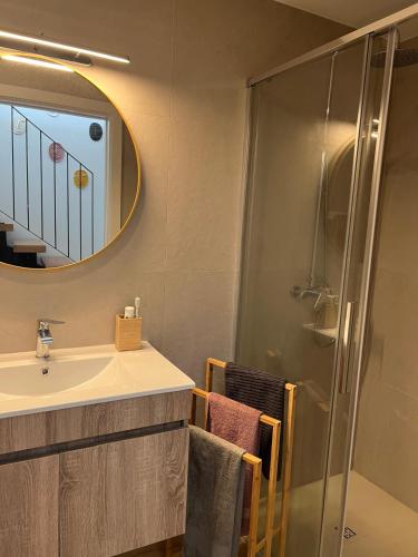 a bathroom with a shower and a sink and a mirror at Refúgio do Saltadouro - Entre o Gerês e a Cabreira in Ruivãis