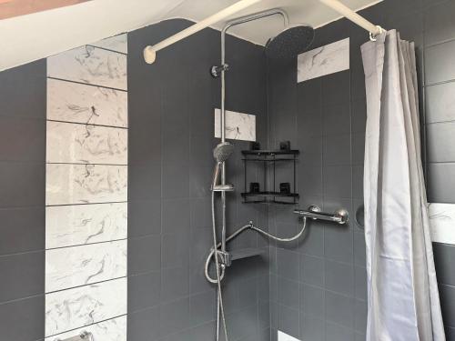 a bathroom with a shower with a shower curtain at Alpenblick am Kienberg in Pfronten