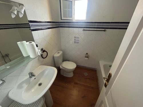 a bathroom with a sink and a toilet at Bungalow con piscina 28 in Gran Alacant