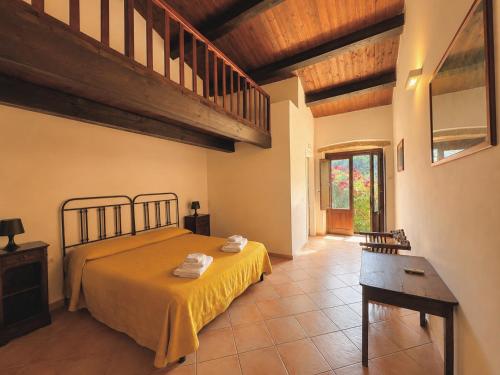 a bedroom with a large bed and a staircase at Azienda Agrituristica Le Puzelle in Santa Severina