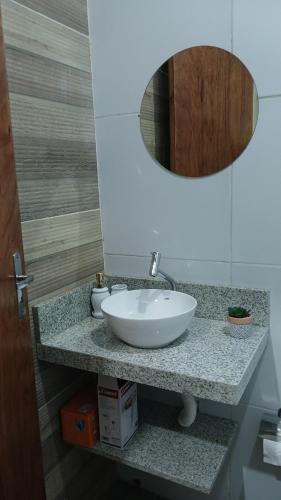 a bathroom with a white sink and a mirror at Casa Napolitana in Uruguaiana