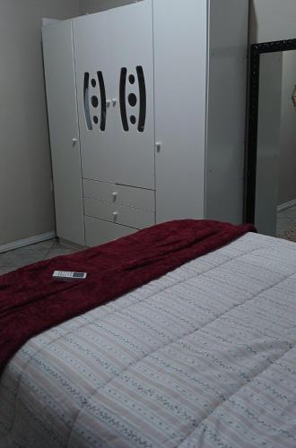 a bedroom with a bed and a dresser at Casa Napolitana in Uruguaiana