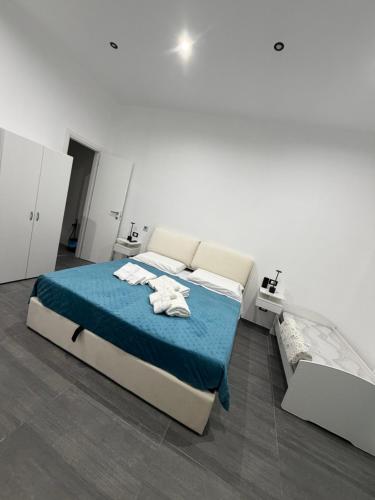 a bedroom with a bed with towels on it at B & B Yaya in Taranto