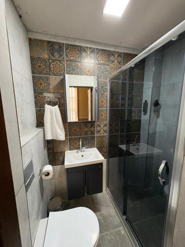 a bathroom with a toilet and a sink and a shower at Avlia Konakları in Edirne