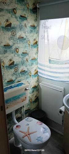 a small bathroom with a toilet and a sink at Sunset Seeker Morecambe in Morecambe