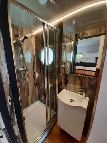 a bathroom with a shower and a sink at Domki pływające HouseBoat4U in Ruciane-Nida