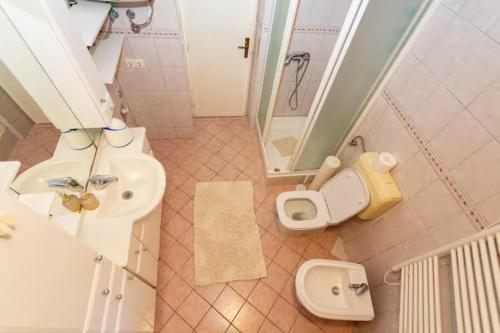 a bathroom with a sink and a toilet and a shower at House Roso in Makarska