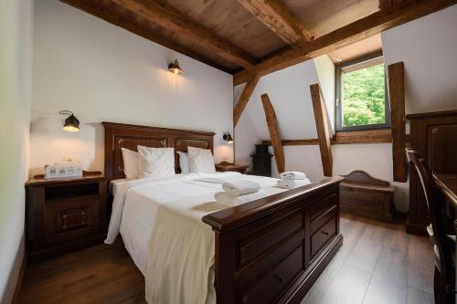 a bedroom with a large bed and a window at Casa Chitic Hotels in Braşov