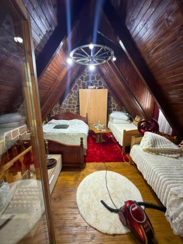 a room with two beds in a attic at Vikendica Avlija in Rožaje