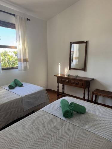 two beds in a room with a mirror and a desk at Los Porches K28 in Playa del Ingles