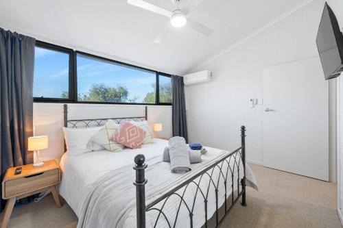 a bedroom with a bed and a large window at Central Freo Hideaway in Fremantle