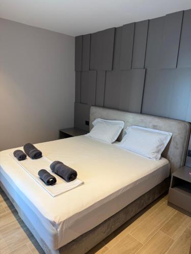 a bedroom with a bed with two towels on it at Dengu Luxury Apartments in Golem