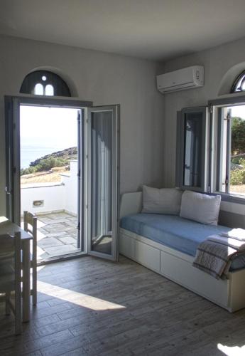 a bedroom with a bed and a view of the ocean at Rosalie Home - Open Sea Studio in Tinos