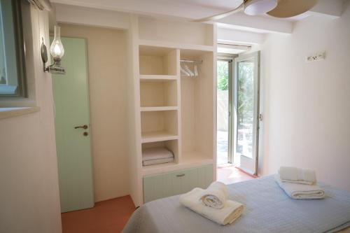 a bedroom with a bed with towels on it at Limni house in Kythira
