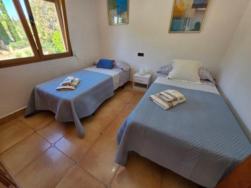 a room with two beds with towels on them at Chalet Paradise of the Mediterranean in La Nucía