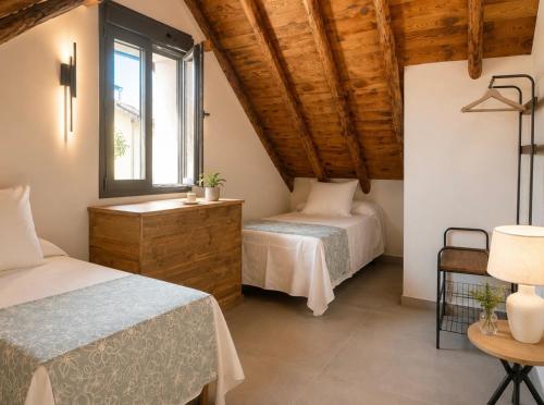 a bedroom with two beds and a window at La casa Suiza in Cercedilla