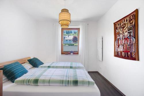 a bedroom with two beds and a window at Ferienwohnung Krokus in Weiler-Simmerberg