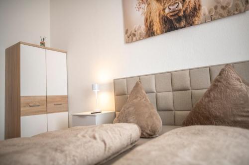 a bedroom with a bed and a picture of a lion on the wall at FeWo LUNA in Riesa