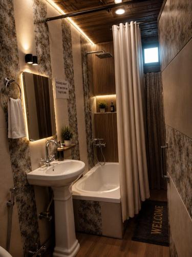a bathroom with a sink and a toilet and a tub at Dilnaaz Group Of Houseboats in Srinagar
