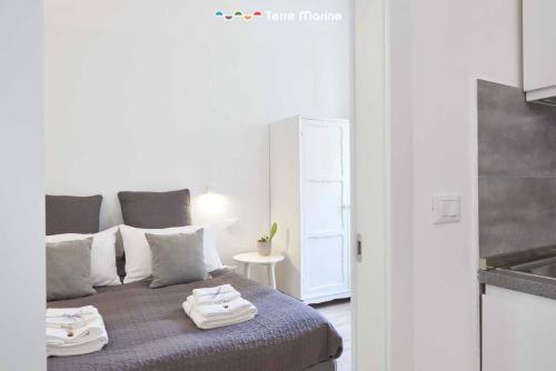 a bedroom with a bed with two towels on it at Urban Chic, Terre Marine in La Spezia