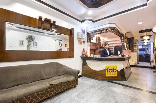 a woman standing at a counter in a store at FabHotel Delhi Continental in New Delhi