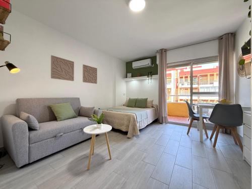 a living room with a couch and a bed at Hercules Cozy Studio - City Center and Near Beach in Benalmádena