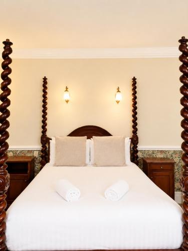 a bedroom with a large bed with two white pillows at The Lairgate in Beverley
