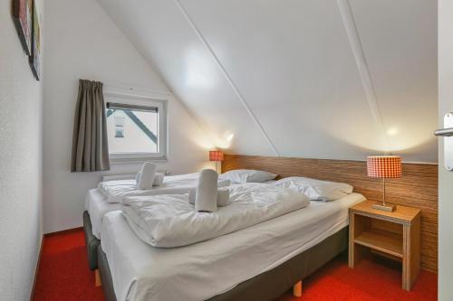 a bedroom with three beds in a room at Landal Winterberg in Winterberg