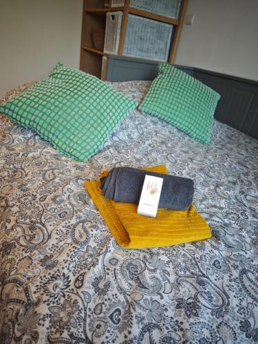 a bed with two pillows and a towel on it at Nature stopover in green Provence in Artigues