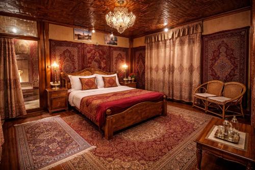 a bedroom with a bed and a chandelier at Dilnaaz Group Of Houseboats in Srinagar