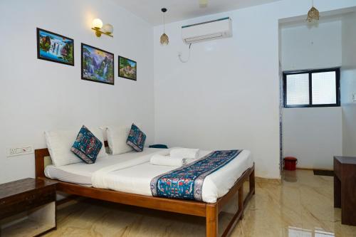 a bedroom with a bed in a room at Sarovar Morjim in Morjim