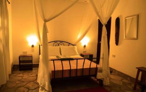 a bedroom with a bed with a canopy at Caffè Roma l'originale in Kampala